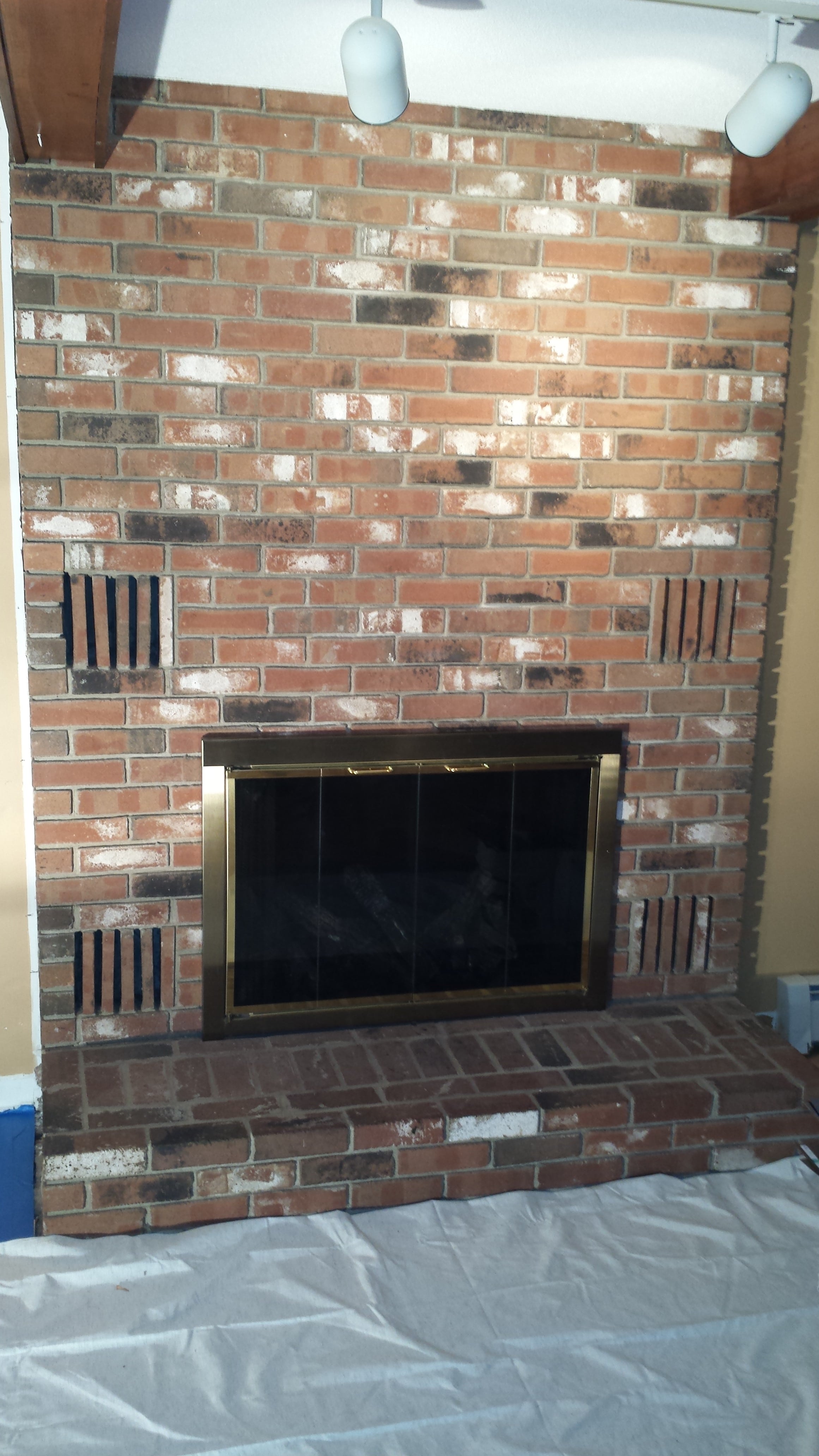 Before photo of an old brick fireplace set to be redone with Norstone Aztec XL Stone Veneer